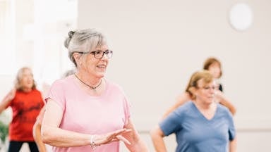 Elderly Woman in Pink Shirt Dancing