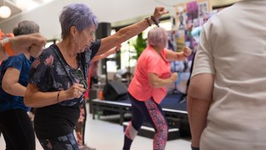 Group of senior women engaged in fitness activities indoors, promoting healthy aging.